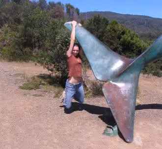 Vicky Argyle hanging from a whale fin