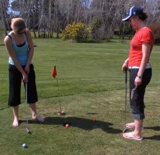 Jane Soper watching Estelle Baker putting