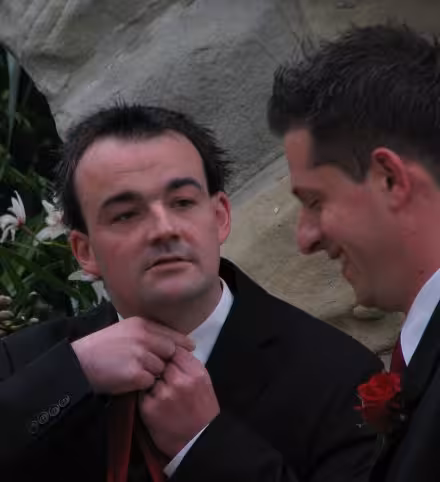 Nick (right) laughing at Leigh's attempts to tie a tie