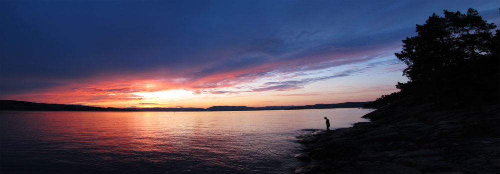 Panorama of sunset near Ingierstrand just outside of Oslo, Norway. Irene on the shore.