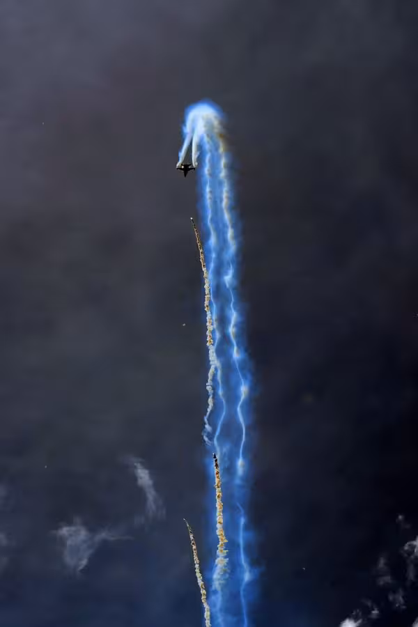 A steep climb, including dropping counter measures. I did some "Photoshopping" (I actually used the GIMP) to show up the exhaust plume and counter measures better.